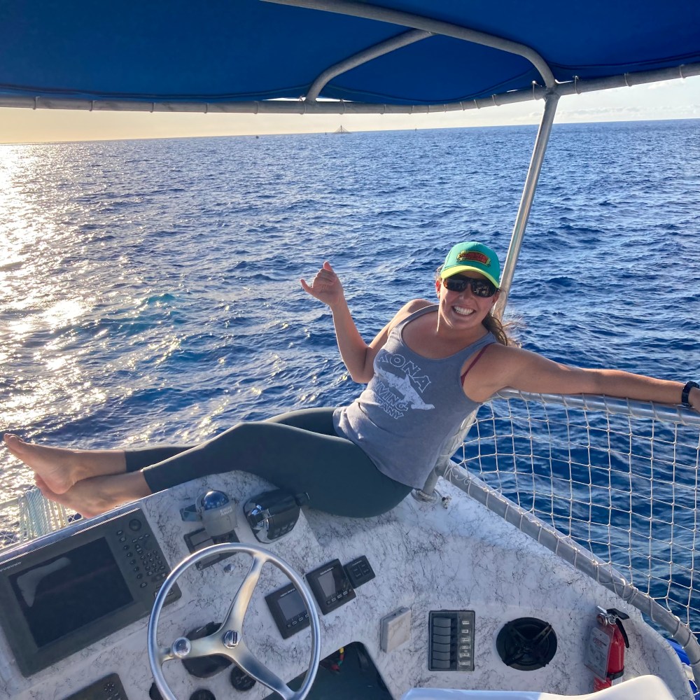 a person riding on the back of a boat in a body of water