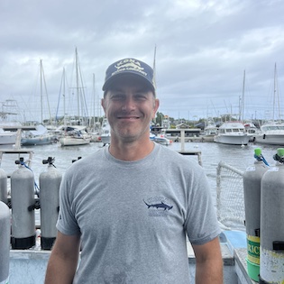 a man standing in front of a boat